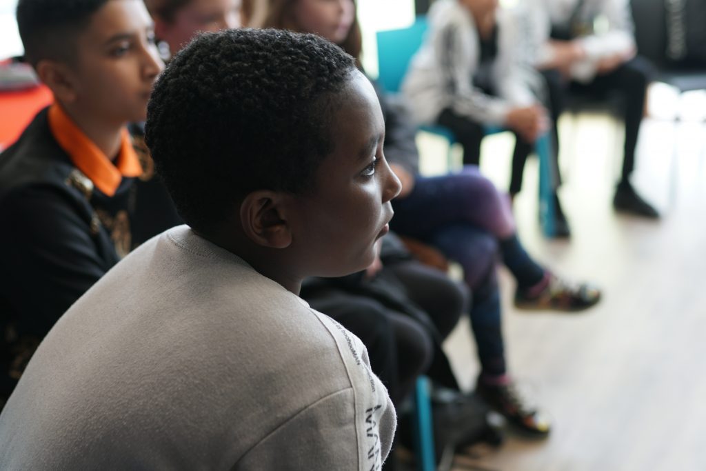 Young people sit in a circle