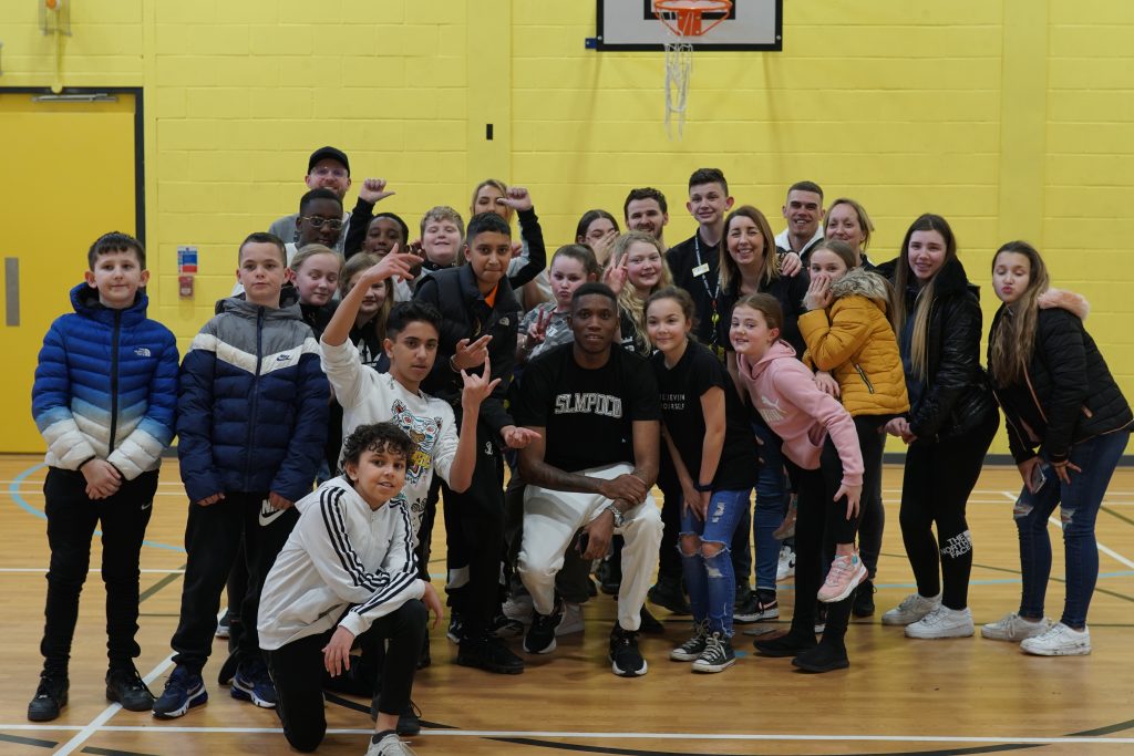 A group photo of around 30 young people and Maxsta