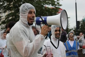 An image of a man with a mega-phone from the first political event of Peacophobia, staged with a modified car club in protest against Islamophobia.