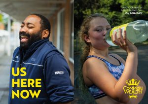 A composite image of a black man in q blue fleece laughs. A white teenager drinks from a bottle of lemonade. The words "Us Here Now" are in yellow in the bottom left corner