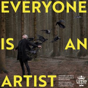 A man dressed in black, stands with his arms open in a wood. Crows fly behind him. The words "Everyone is an Artist" are over the image