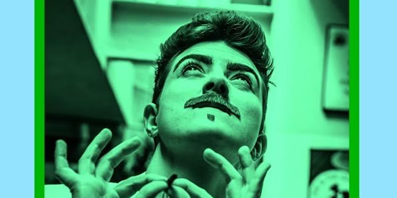 Photographic portrait in green and black of drag king Len Blanco