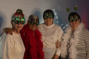 A group of 4 people with christmas glasses on