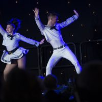 Two young tap dancers dressed as sailors perform on stage