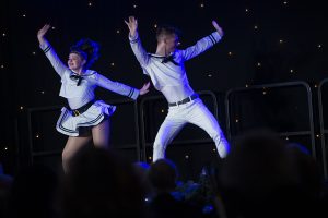 Two young tap dancers dressed as sailors perform on stage