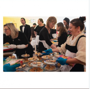 Black tie hosts prepare an afternoon tea