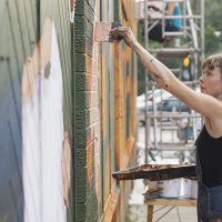 Artist Helen Bur painting the wall