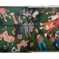 Photo montage of a mural showing over 50 people lying on the grass