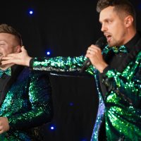 Band The Bowtie Boys perform for the crowd wearing gorgeous green sequins