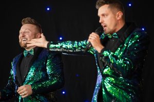 Band The Bowtie Boys perform for the crowd wearing gorgeous green sequins