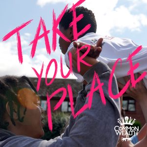 The words "Take your Place" are written in pink over a photograph of a teenage boy lifting another boy into the air - he looks like he is flying