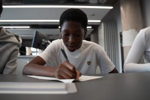 Young boy writing at a desk