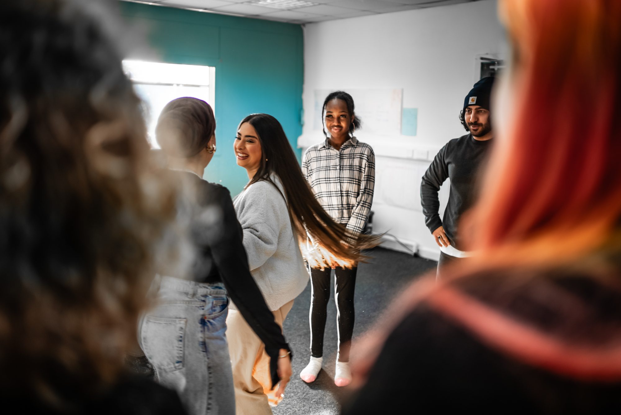 A group of people smiling while part of a research and development process.