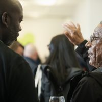 Audience members deep in discussion at launch event.