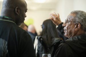 Audience members deep in discussion at launch event.