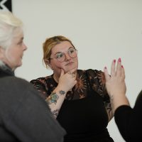 Audience members deep in discussion at launch event.