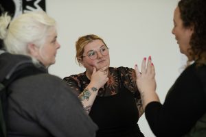 Audience members deep in discussion at launch event.