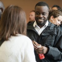 Audience members deep in discussion at launch event.
