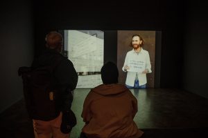 Audience members viewing art piece
