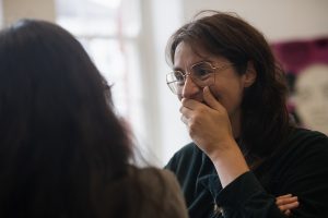 Audience members smiling and speaking to each other at launch event.